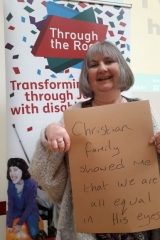 Karen holding a sign saying "Christian Family taught me we are all equal in his eyes"