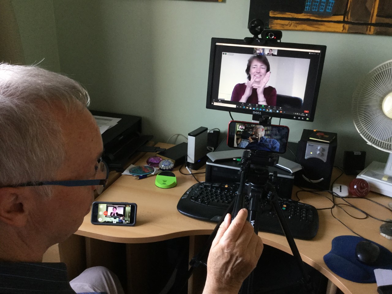 Myles watches Janet signing on screen to relay the image to Frenchie