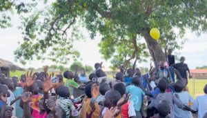 A group of people from the area batting some balloons to each other