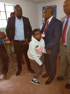 Esther with Pastor Davis and her sponsor - the government official who was so touched by her story that he awarded her a full educational scholarship