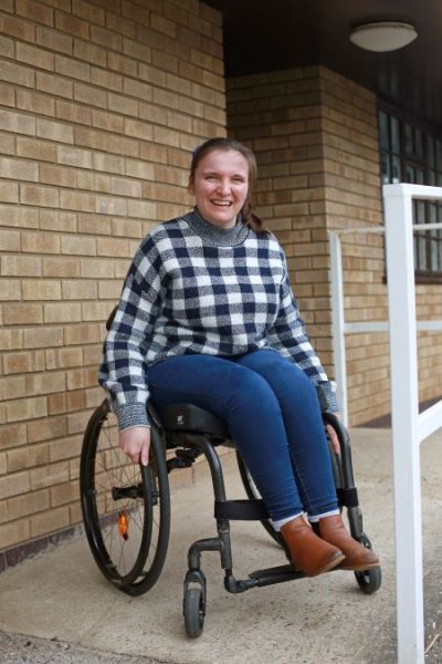 Katie Mobbs, one of the TTR team, sits in her wheelchair at the top of a ramp allowing access to a church hall