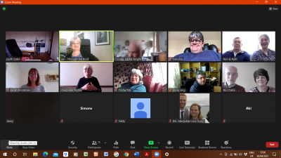 A screenshot from a Zoom event, with 14 people smiling and chatting on screen