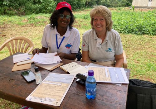 Two team members waiting to see potential recipients at the admin desk