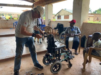 a tech works on adjusting a child's wheelchair