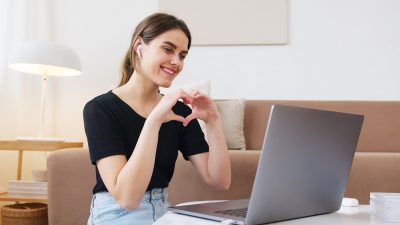 woman-making-heart-with-hands-while-having-video-call-4492134