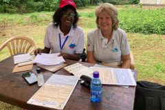 Two team members waiting to see potential recipients at the admin desk