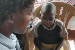 A child and team member praying together