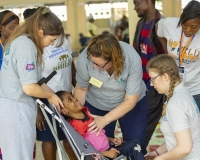 Tracey-Lydia-and-Lauren-support-a-young-Ghanaian-boy-in-his-new-wheelchair-2026
