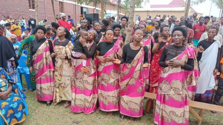 About 20 members of the deaf choir, all dressed in red 