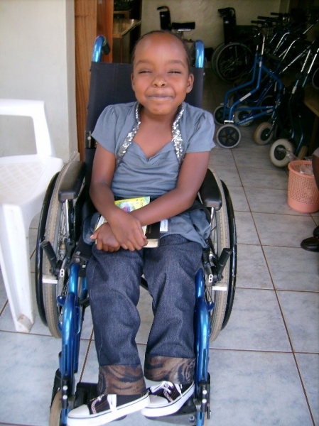 A child in their new wheelchair on one of our Wheels for the World distributions