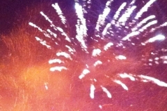 A firework exploding against a smoky night sky