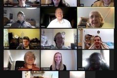 A screenshot from a Zoom event, with about a dozen people smiling and chatting on screen