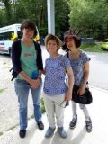 Emma is standing in front of a holiday minibus with two other women, both guests on a TTR holiday. They are all smiling and dressed for a trip out. 