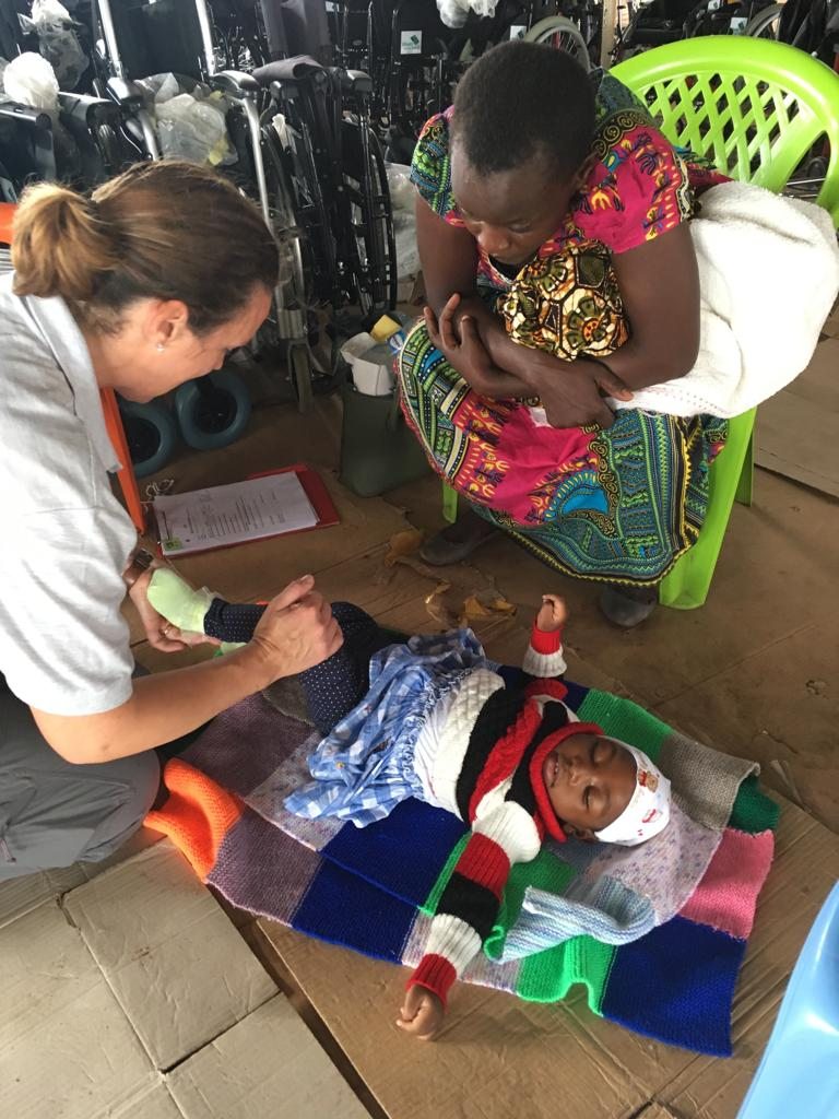 Helen shows a lady some exercises she can do to help her daughter