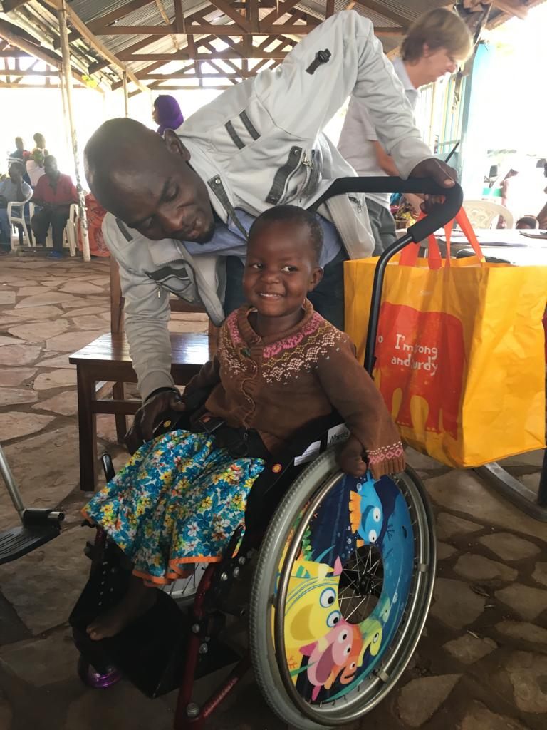 Feis smiling in her new wheelchair