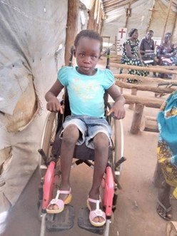 Gladys sits in her new wheelchair