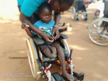 Blossom, a young girl, sitting in her new chair