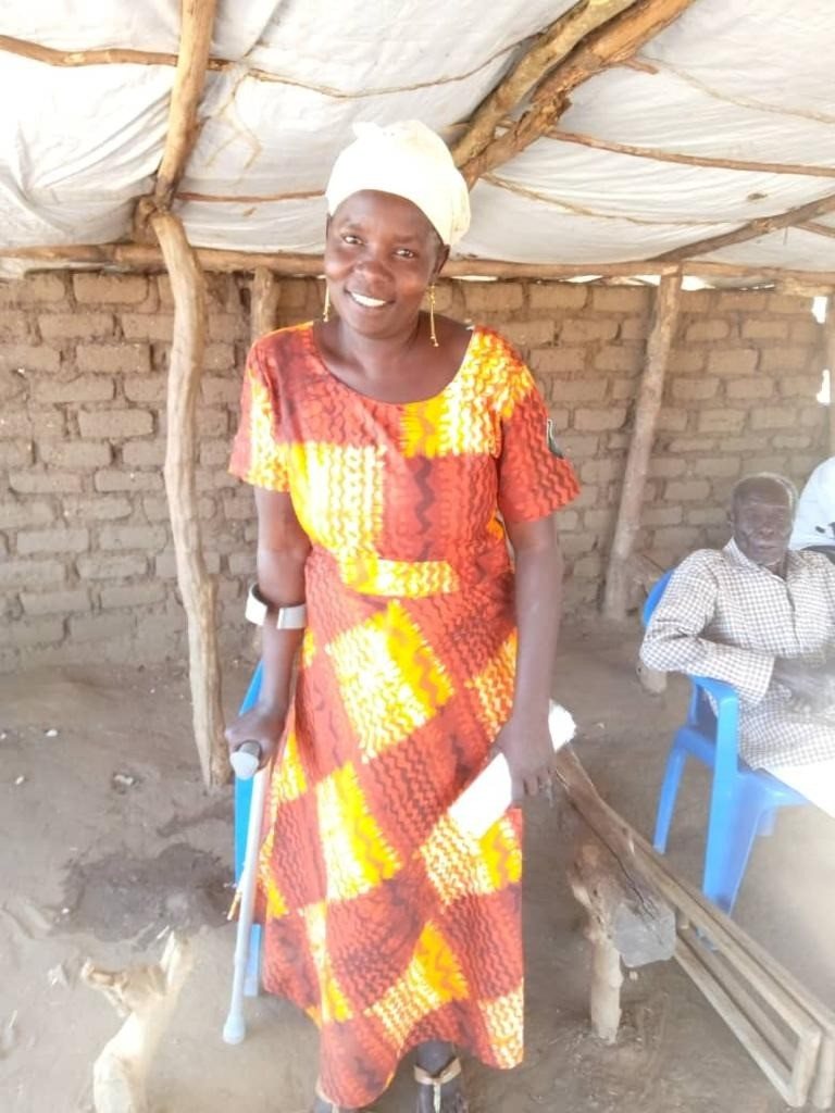 Charity, a recipient, standing with her new crutches