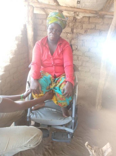 Aliru sits in her new wheelchair