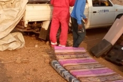 The HHA team arriving in the area and unloading wheelchairs from the back of a truck