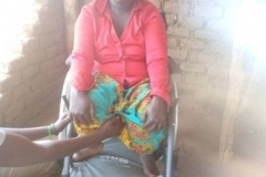 Aliru sits in her new wheelchair